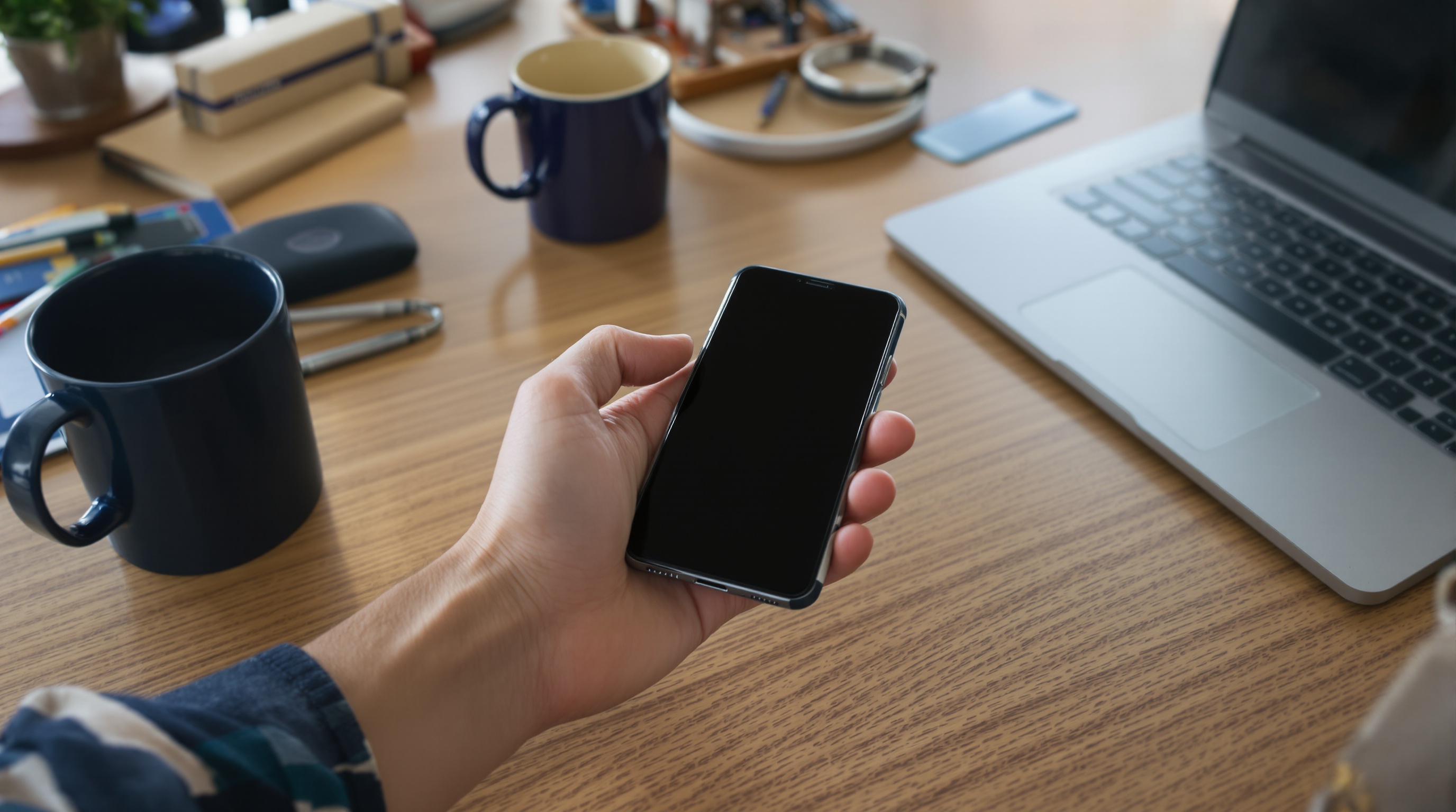 Stack of expired driver licenses and passport pages on a dark surface, dramatic side lighting creating long shadows, shot on Fujifilm X-T5 with 56mm f/1.2