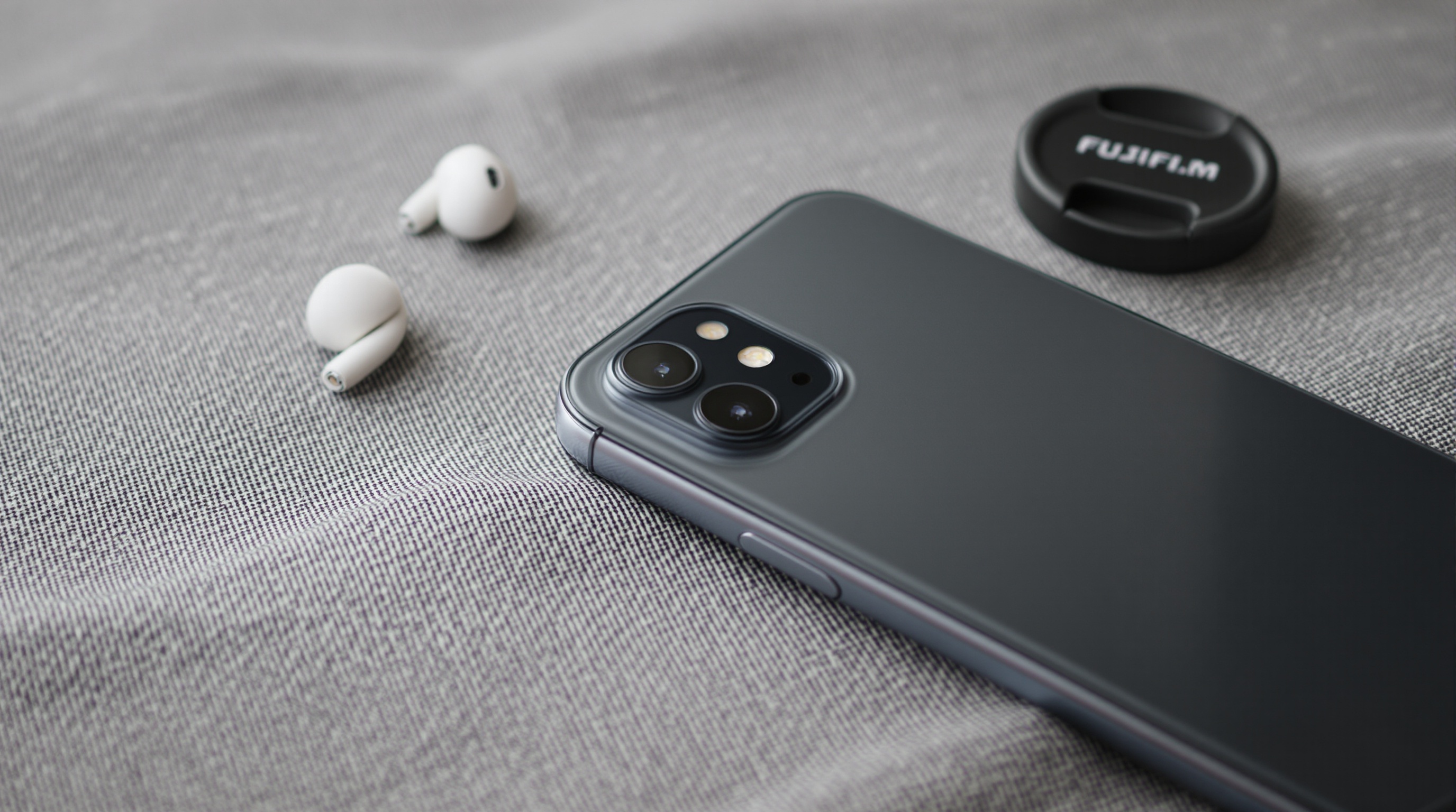 Close-up of a phone screen showing a photo gallery interface, shot with shallow depth of field