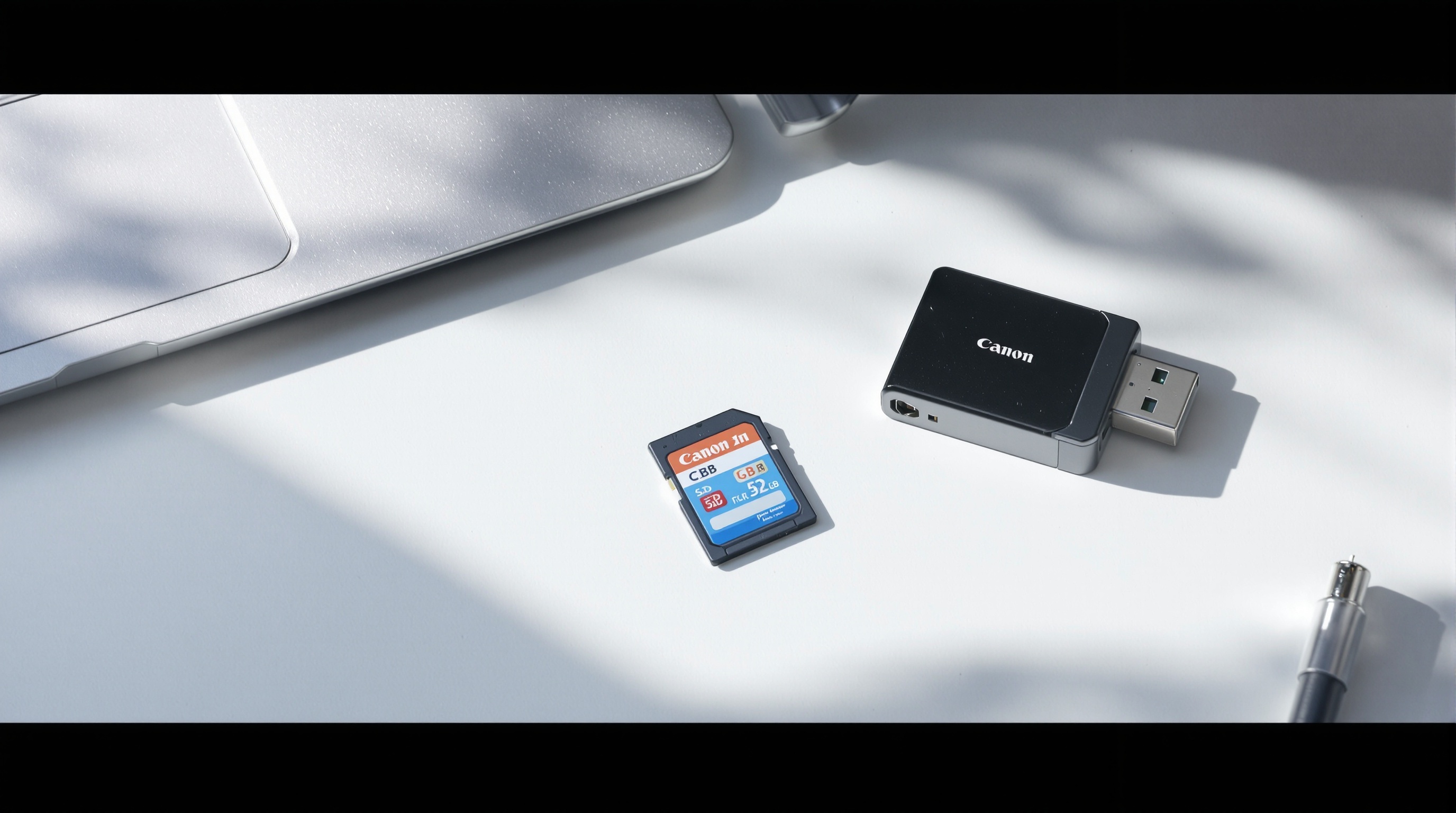 An SD card and card reader sitting next to a laptop on a clean desk, soft window light, editorial style