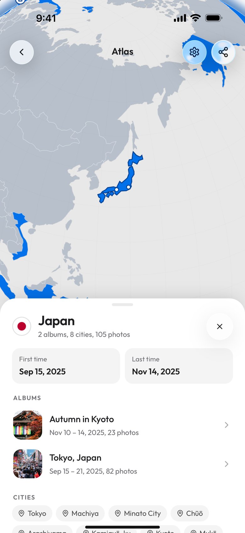 Japan opened from the Atlas list on a phone: the globe turned to East Asia with Japan outlined in blue, then Japan with 2 albums, 8 cities, 105 photos, First time Sep 15, 2025 and Last time Nov 14, 2025, the albums Autumn in Kyoto and Tokyo, Japan, and the first of its cities