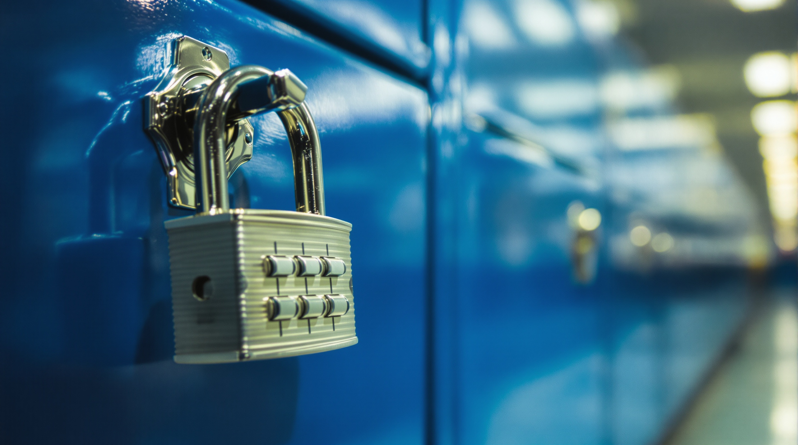 Close-up of a combination padlock on a school locker, shallow depth of field with blurred locker rows in background, fluorescent hallway lighting, shot on Ricoh GR III, slight film grain